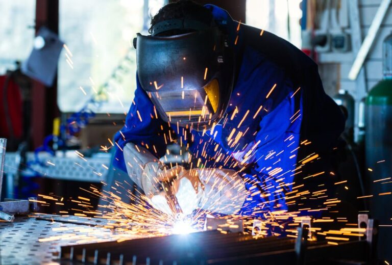 man welding blue